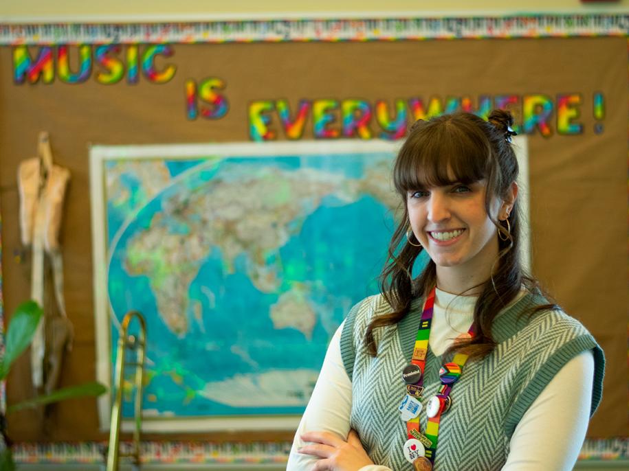 Alum Shannon O'Leary stands in front of a map in her elementary school classroom.