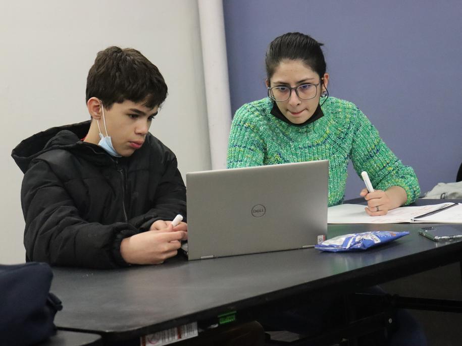 Graduate student Injila Rasul works with a student at the Holyoke Boys and Girls' Club.