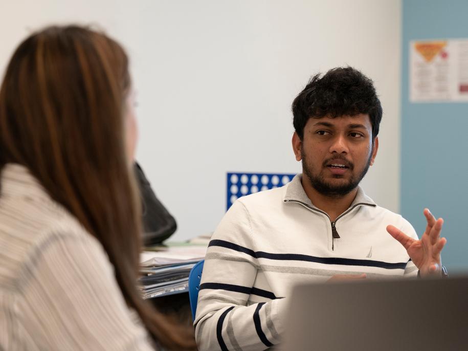 Graduate student Krishna Kathala discusses an idea with Ivon Arroyo.