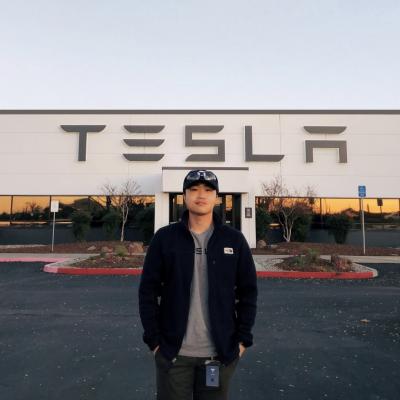 Jabin Chen in front of Tesla