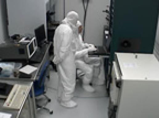 Researchers in a clean room lab