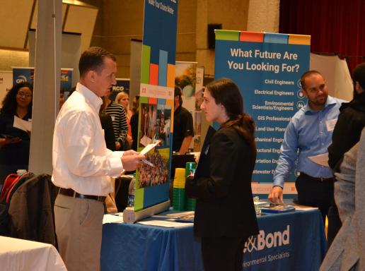 Student meets with industry recruiter a career job fair