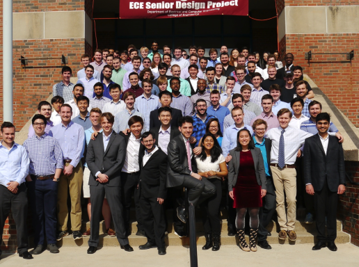 ECE students standing on steps of Marcus by senior design banner