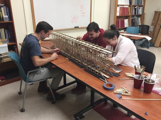 groups of students work on bridge for competition