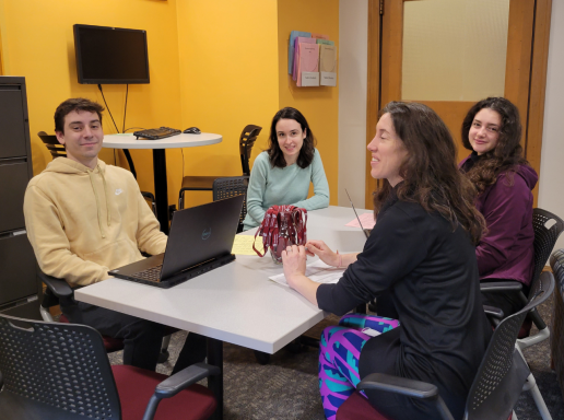 advisors and students conferring in the office of student affairs