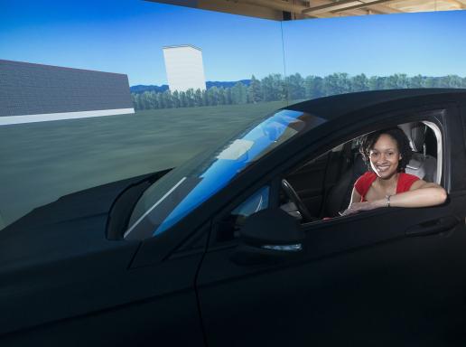 Professor Shannon Roberts sits in test vehicle in human performance lab