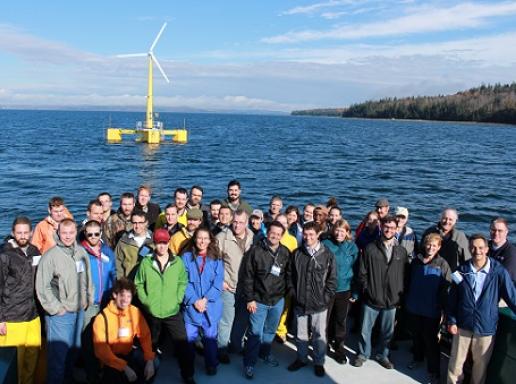 wind team on boat with turbine in view
