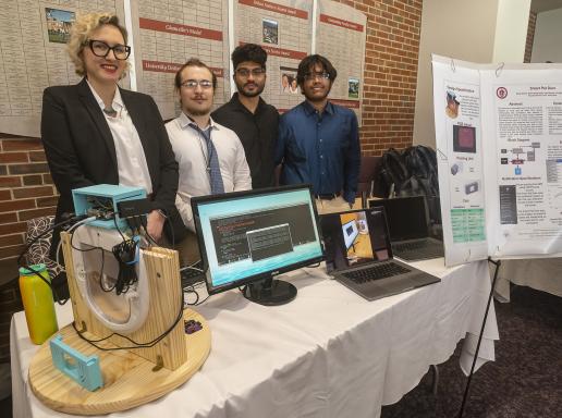 Group of students standing by senior design project