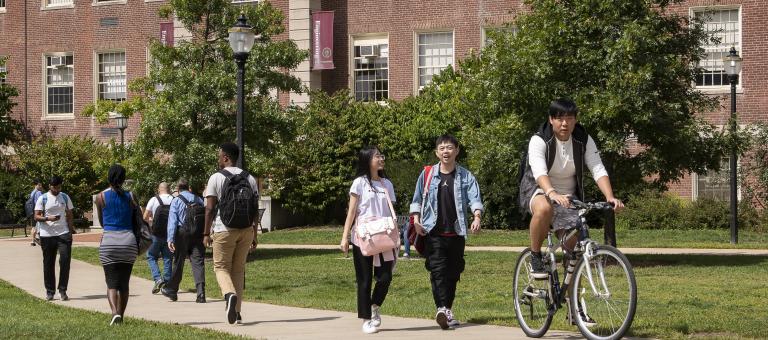 Students walking between classes by Marston Hall