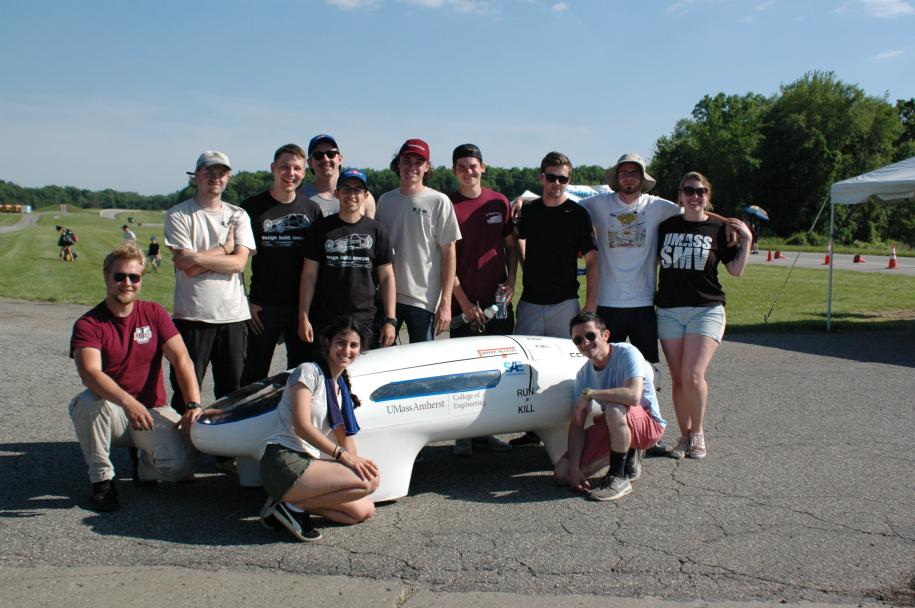 Student team in front of a supermileage vehicle