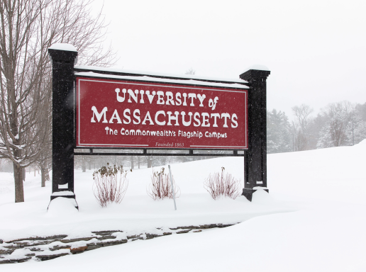 UMass Amherst sign covered in snow