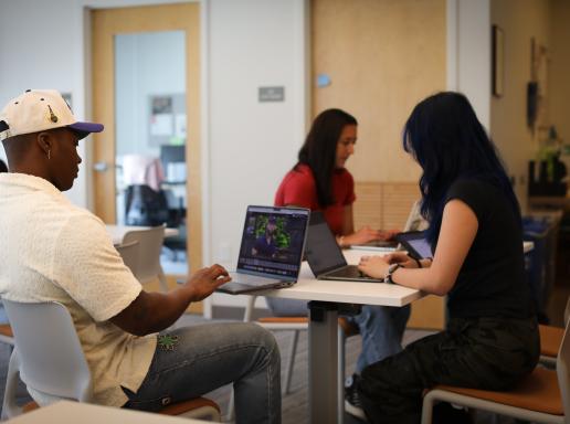 Several students work on their laptops in the Honors Hub at the University of Massachusetts