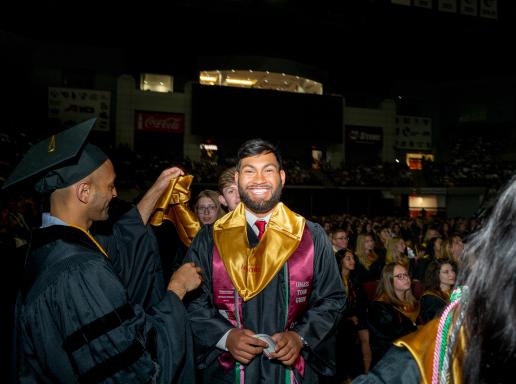 A student is awarded their gold stole during Celebration of Excellence at the University of Massachusetts