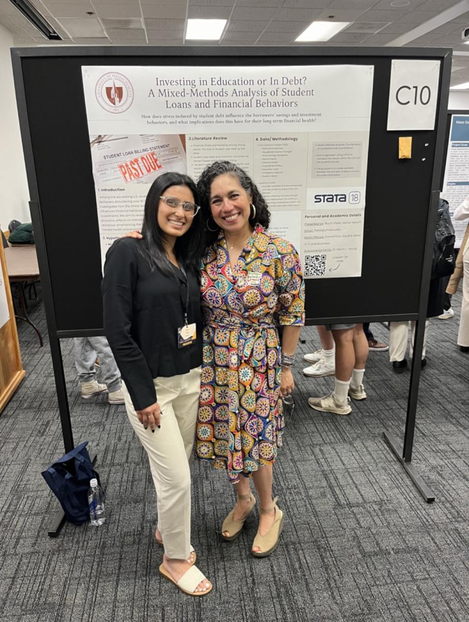 Ruchi and Dean Castaneda stand in front of her poster at MassURC 2024