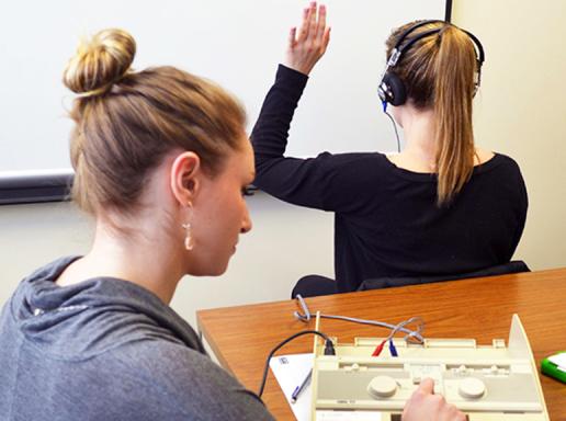 A student administers a hearing test.