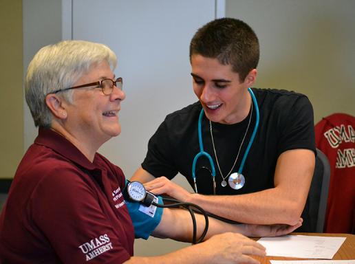Kinesiology student administers blood pressure test