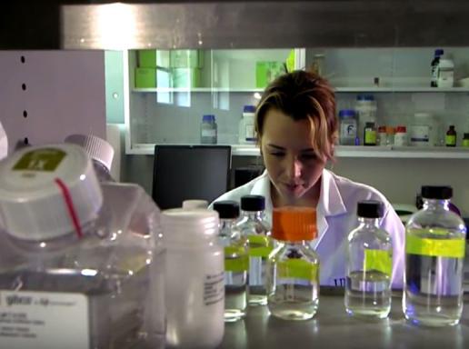 Student in a nutrition lab with vials in the foreground