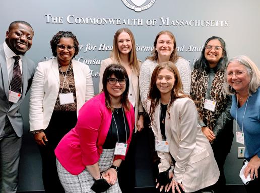 Photo of seven graduate students posing with Risa Silverman, director of the Office of Public Health Practice and Outreach, at the 2023 Student Forum hosted by the Massachusetts Health Policy Forum on Beacon Hill. 