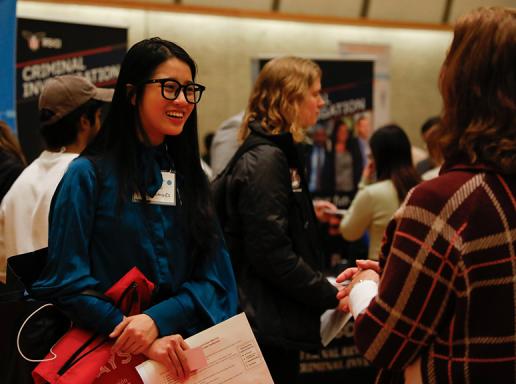 Student speaks with a potential employer at the 2023 SPHHS Career Fair