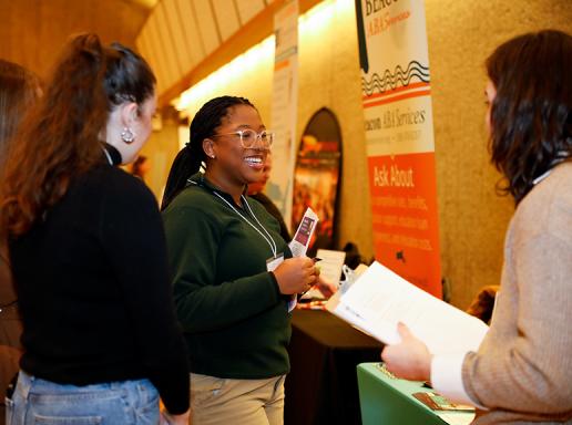 Students speak with a potential employer at the 2023 SPHHS Career Fair