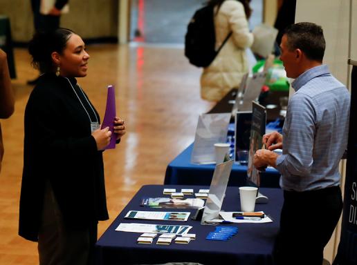 Student speaks with a potential employer at the 2023 SPHHS Career Fair