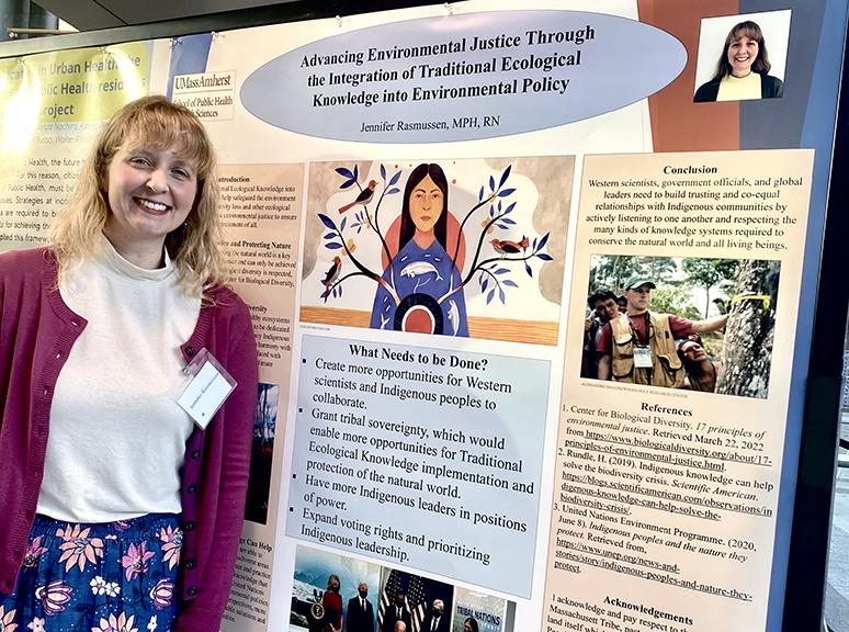 Jennifer Rasmussen presents a research poster at a conference