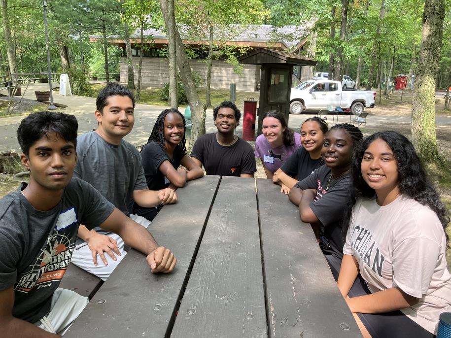 group picture of 7 people at picnic table
