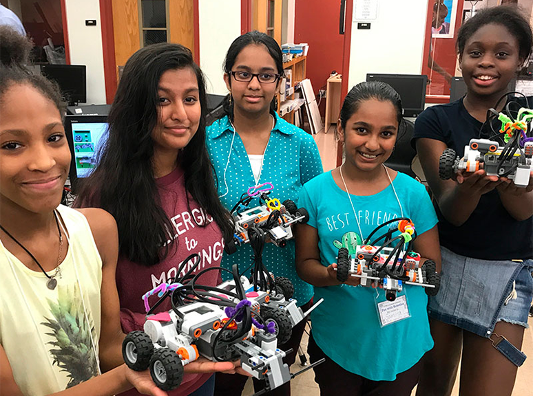 Photo of Community Bots participants holding the robots
