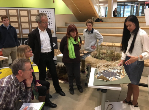 A student presents a landscape architecture design to faculty members