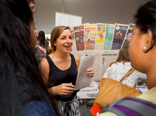 An image from the Student Activities Expo - a student talks to two other students about joining a campus organization