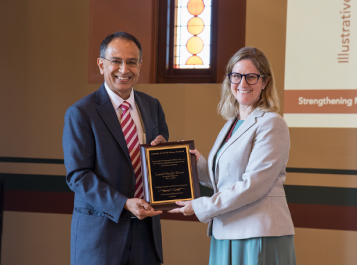 UMass Amherst chancellor presenting award to SBS faculty member