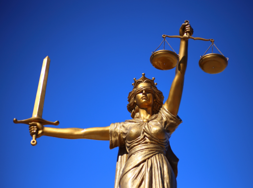 Statue of Justice, holding scales in her left hand and a sword in her right hand. 
